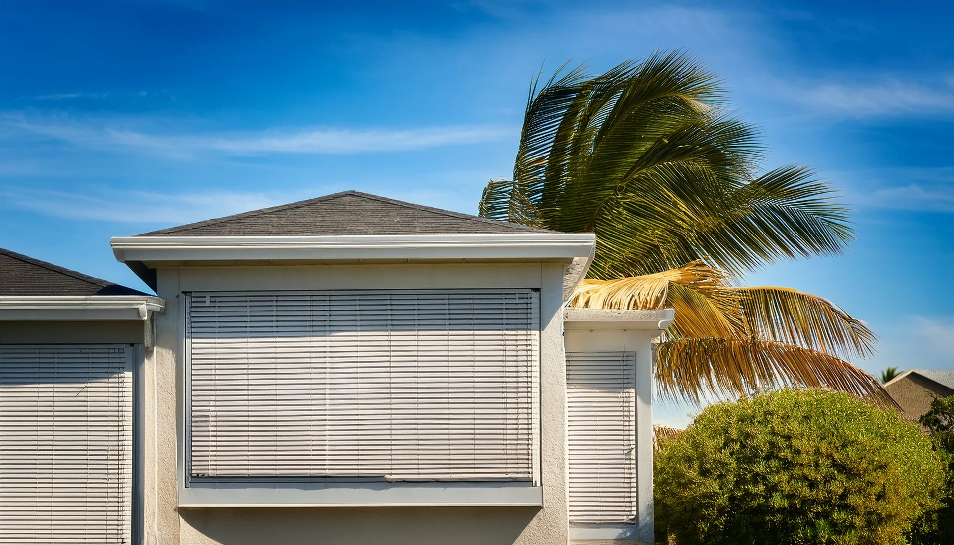 Closing hurricane shutters on a Florida home.
